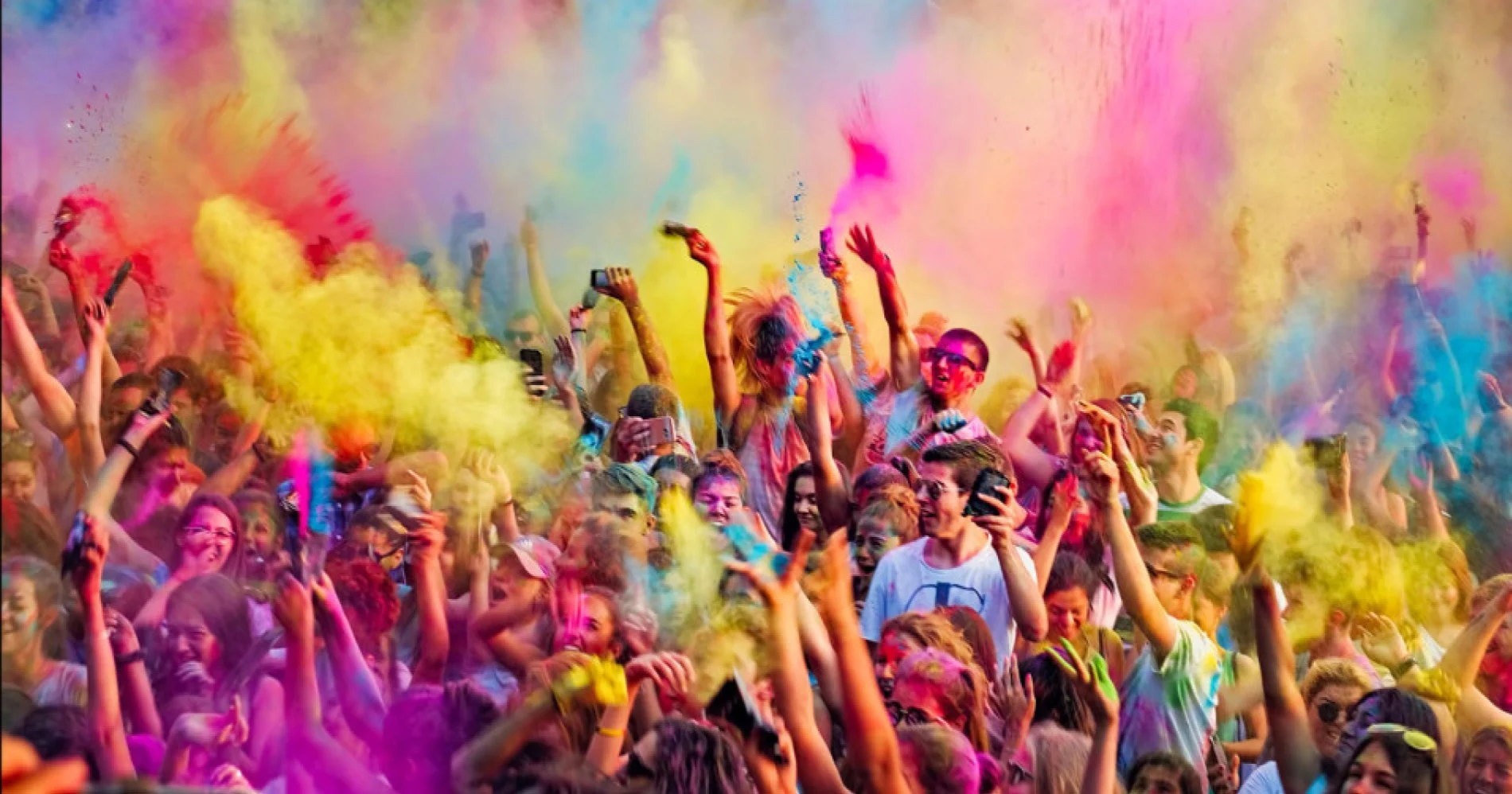 Hands holding colorful Holi powders ready to be thrown, showcasing the festival's spirit of togetherness.