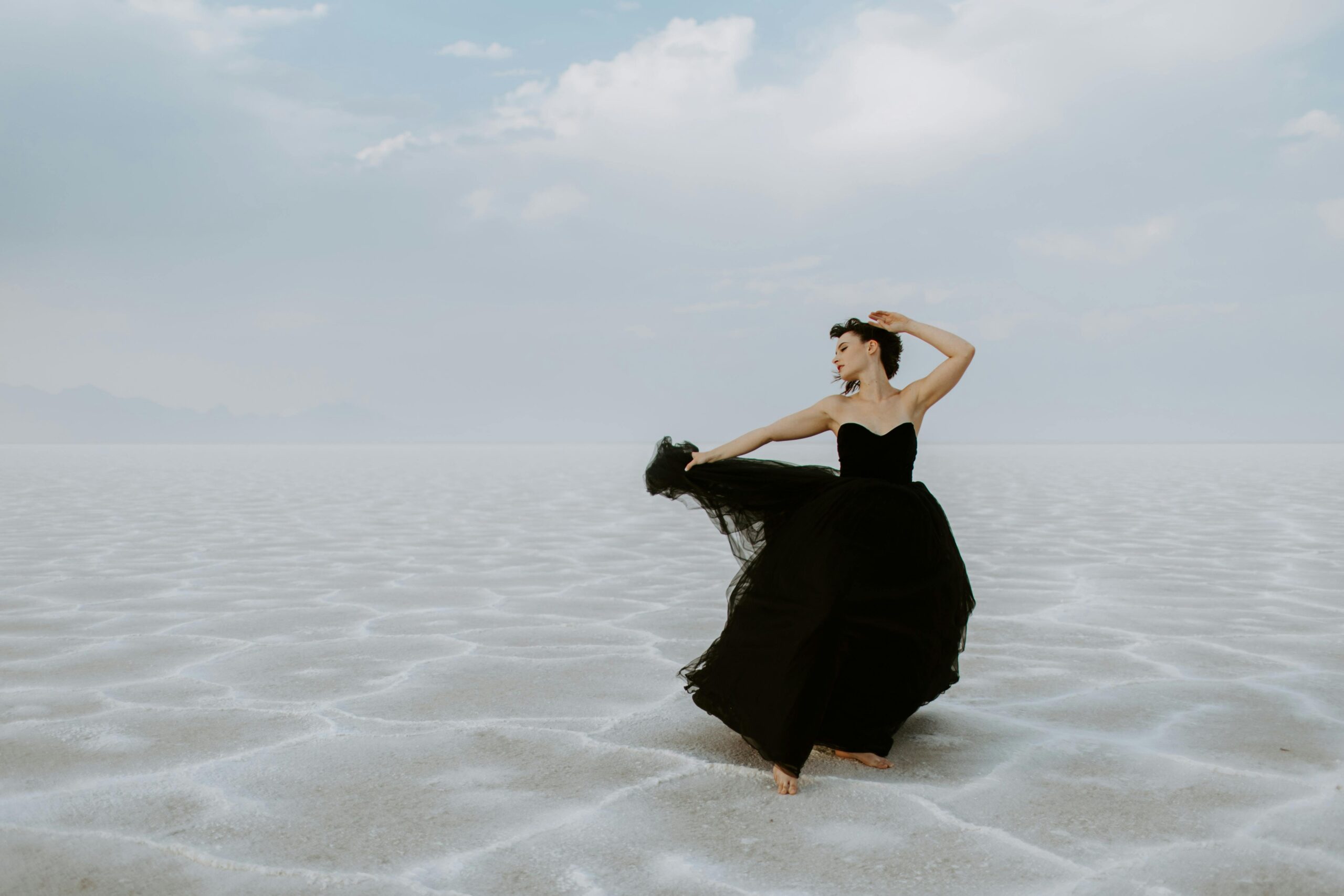 A close-up view of a luxurious black velvet gown with sparkling diamond accessories, showcasing the texture and depth of the fabric and the shimmer of the jewelry.