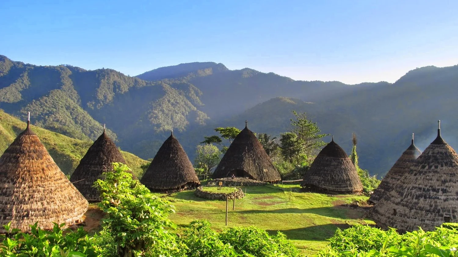 Locals engaging in traditional activities within the serene ambiance of Wae Rebo Village.
